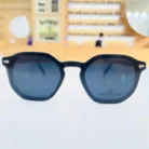 Lunettes clips homme noires portées, monture géométrique épaisse mate avec détails transparents et éléments métalliques visibles.