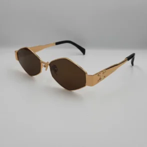 Celine lunette de soleil à monture dorée géométrique, verres bruns, branches gravées et embouts noirs, plaquettes réglables.