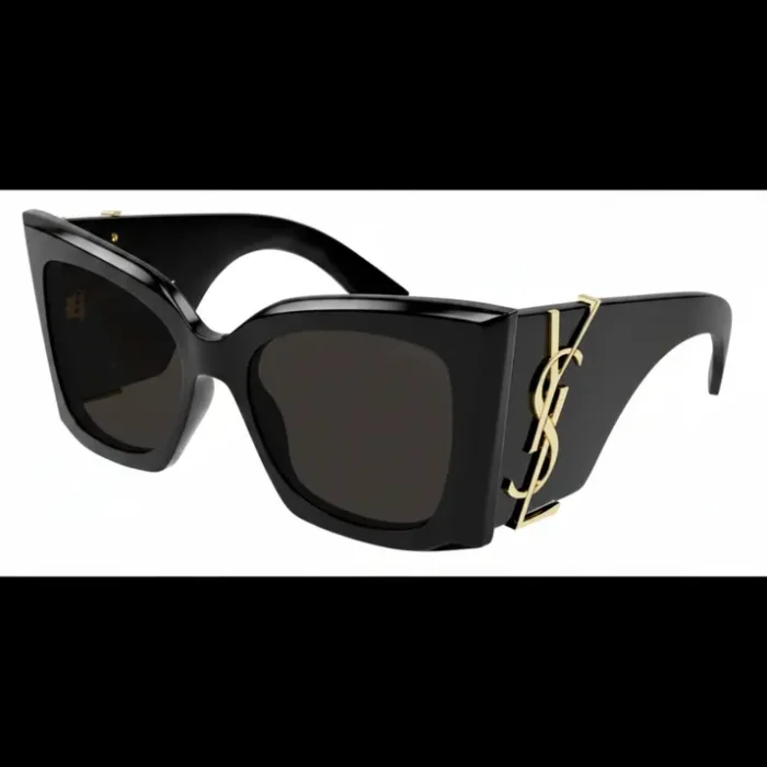 Lunette de soleil Yves Saint Laurent noire à monture épaisse, verres foncés et logo doré sur les branches, forme angulaire.