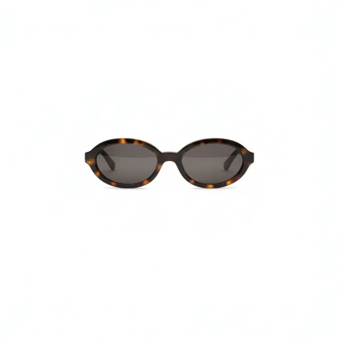 Krys lunettes de soleil ovales noires femme Femme portant des Krys lunettes de soleil ovales noires à verres teintés et branches fines, style moderne.