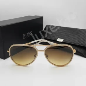 Lunette de soleil Boss style aviator en métal doré, verres ronds dégradés bruns, avec étui rigide noir et boîte Boss.