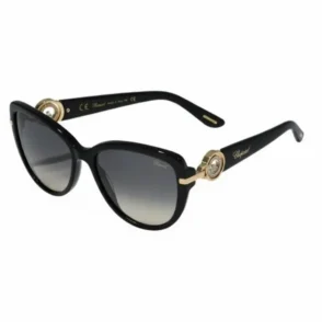 Lunette de soleil femme Chopard noire à monture épaisse, verres dégradés noir-gris et détails dorés sur les branches.
