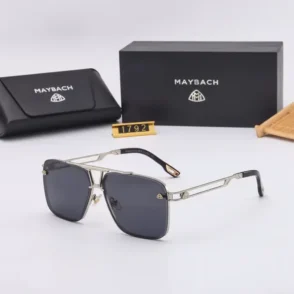 Lunette de soleil homme Maybach à monture métallique, verres carrés foncés, avec étui et boîte Maybach en arrière-plan.