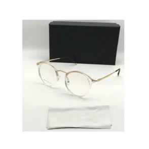Lunette de vue blanche femme à monture transparente ronde, branches dorées avec embouts noirs et plaquettes nasales visibles.