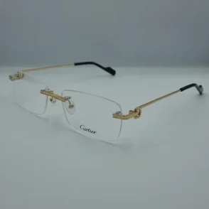 Lunettes de vue Cartier pour homme sans monture, branches dorées fines, embouts noirs, plaquettes transparentes et logo Cartier sur un verre.